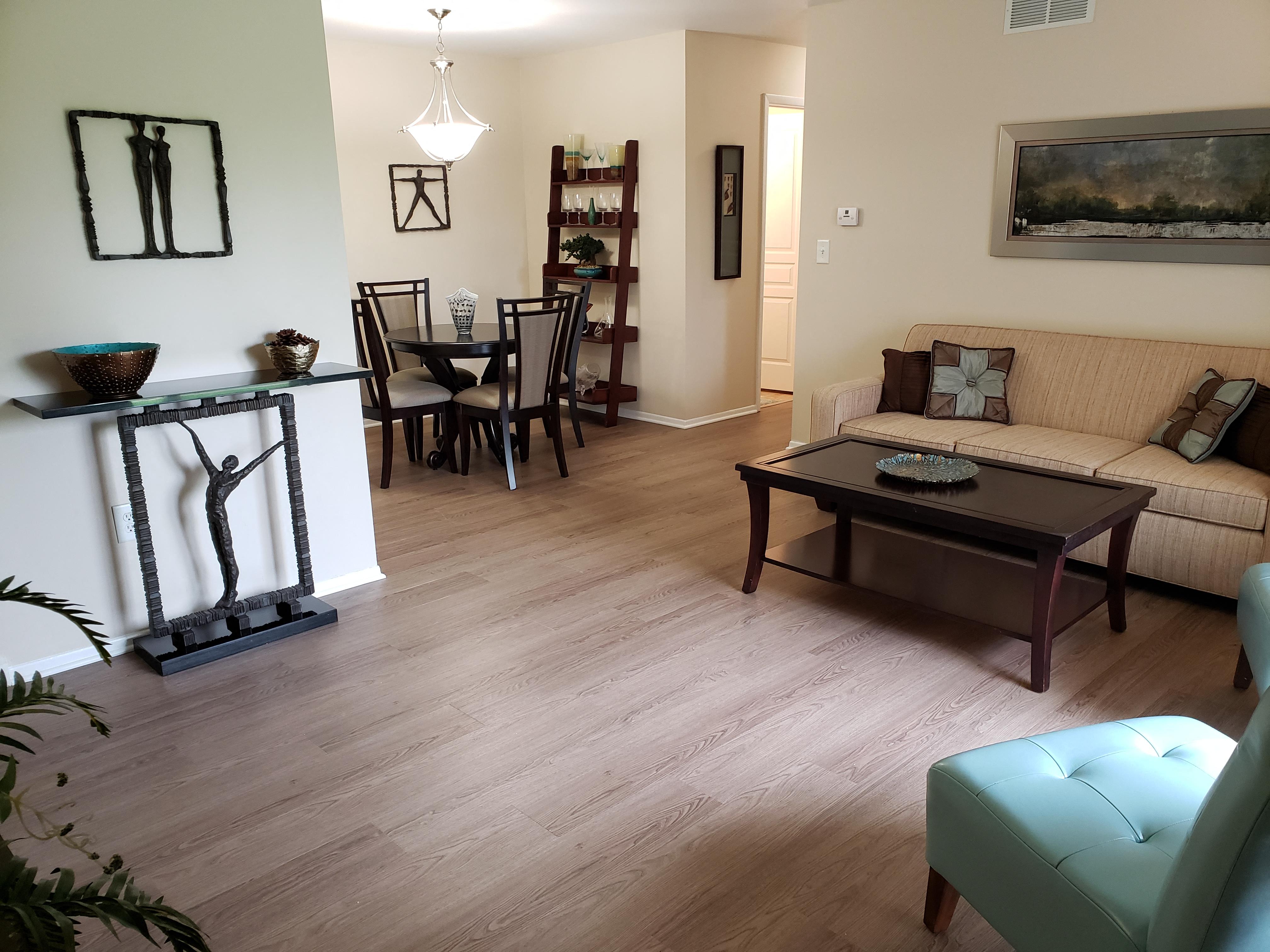 a living room and dining room with a table and a couch